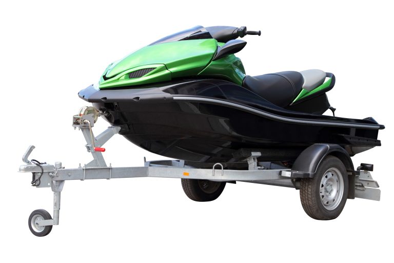 Green hydrocycle on the automobile trailer, isolated on a white background