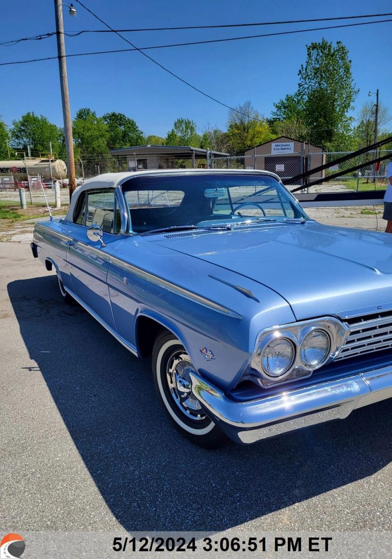 Light blue classic 1962 Chevrolet Impala convertible parked outdoors on a sunny day, featuring chrome details and whitewall tires, ready for vintage car transport