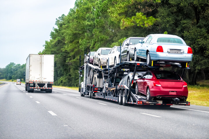 Stinger car hauler shipping a full load of cars on the interstate.